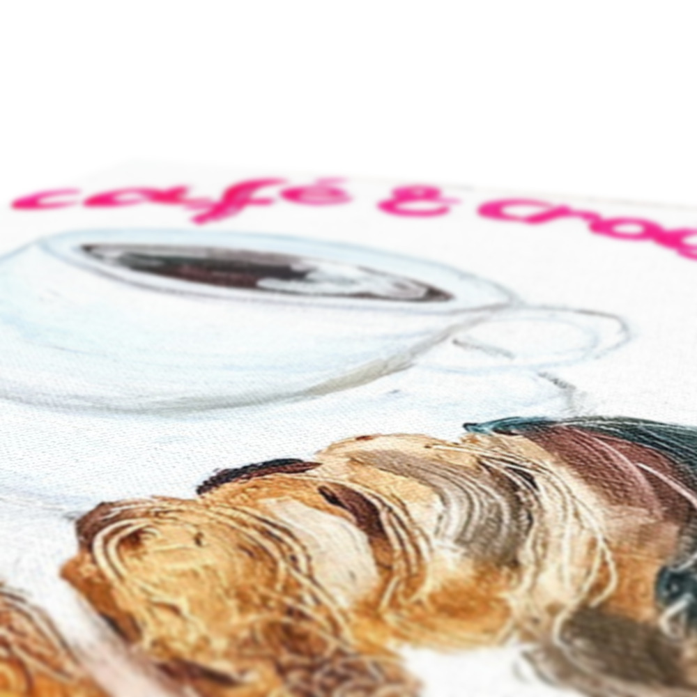 Canvas print of a coffee and croissant with french inscription and atmosphere