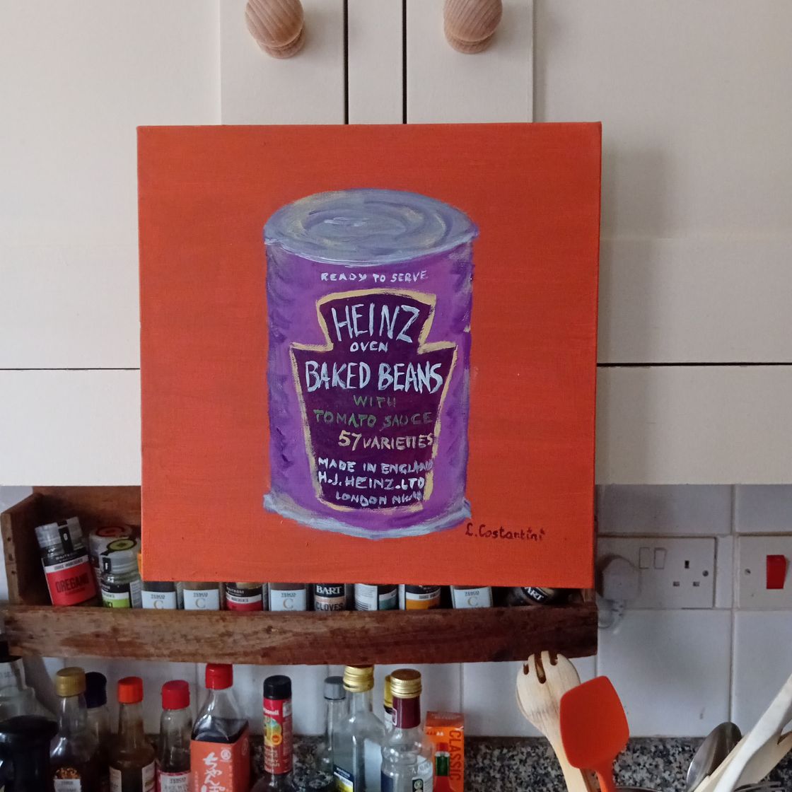 Canvas print of a Heinz baked beans can on a burnt orange background in a kitchen setting.