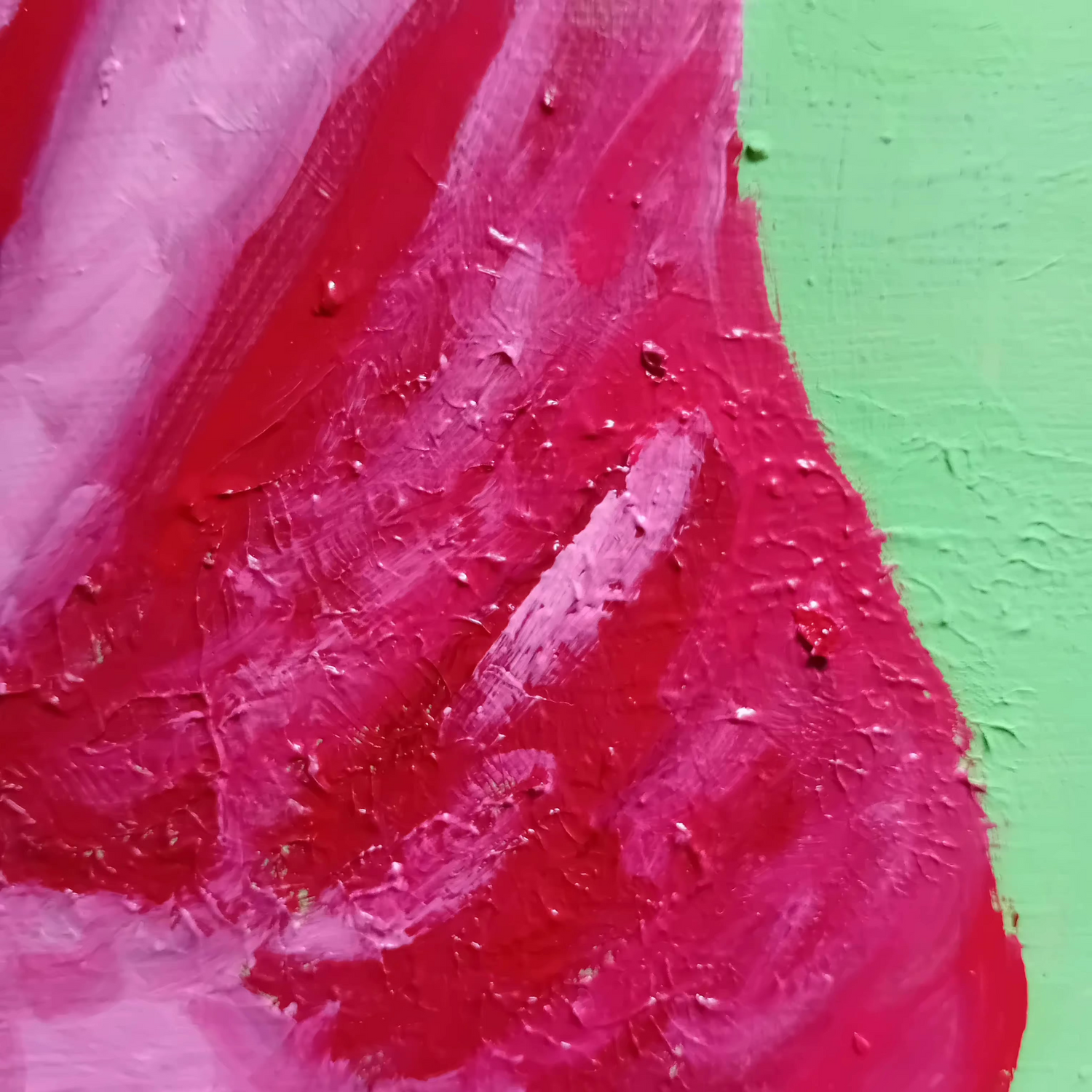 Close-up of textured pink surface with a green background