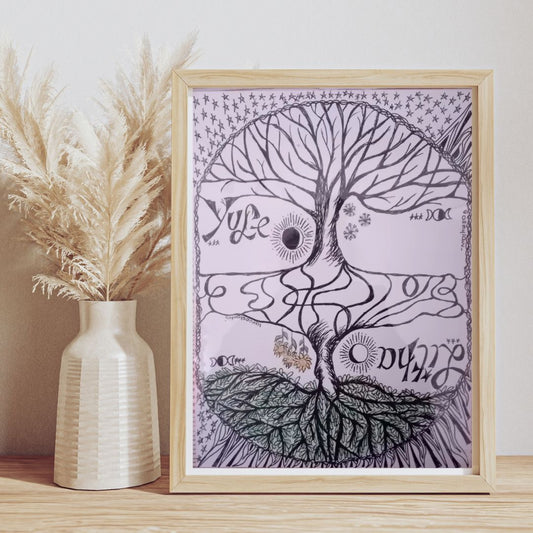 Framed artwork with yggdrasil tree design and Yule and Litha solstices text on a wooden surface with a vase of pampas grass.